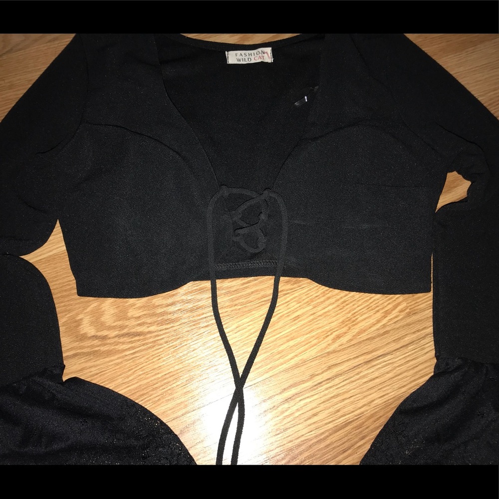 A black lace up , bell sleeve crop top.